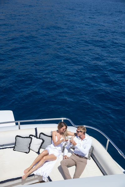 A beautiful couple enjoying a drink on a yacht