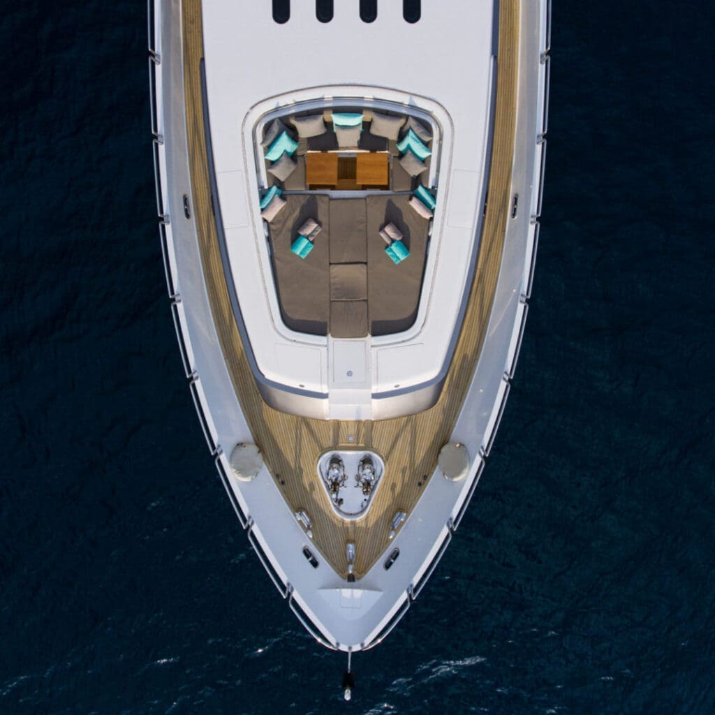 Bow of a luxury yacht with seating area.