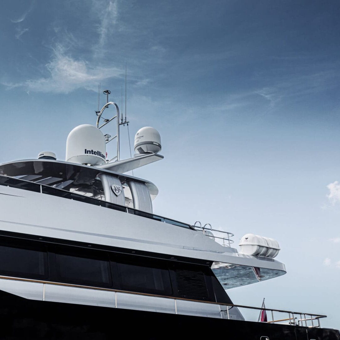 A large white and black yacht at sea.