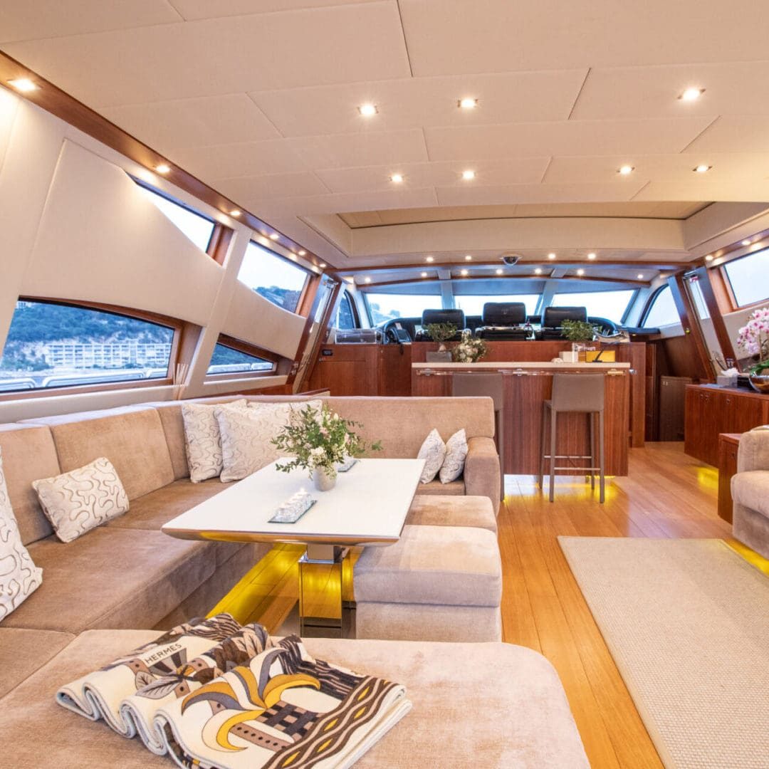 Interior of a luxury yacht with sofas and a table.