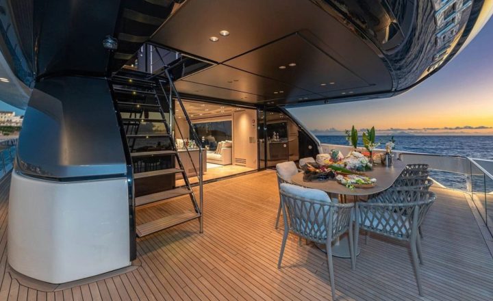 Aft deck of a luxury yacht at sunset.