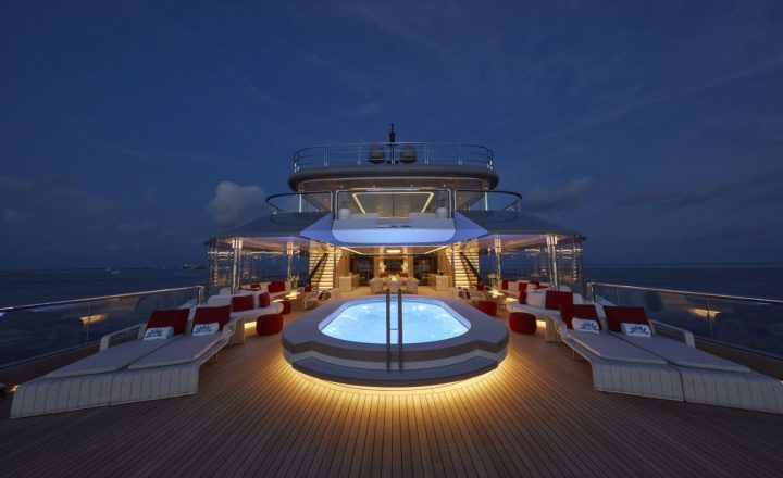 A luxury yacht with a pool on its deck.