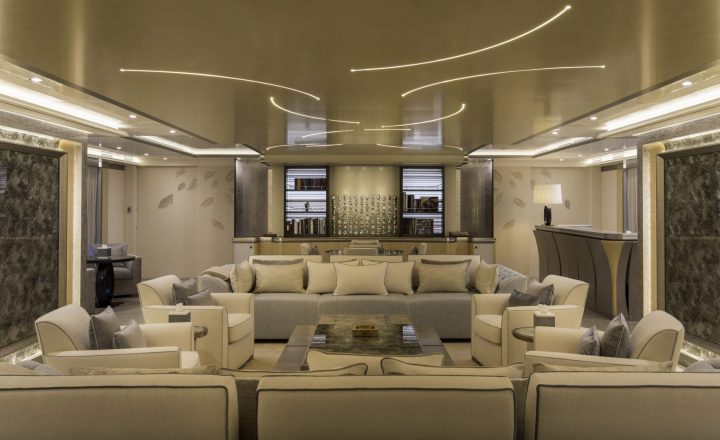 Luxury yacht interior with sofas and bar.