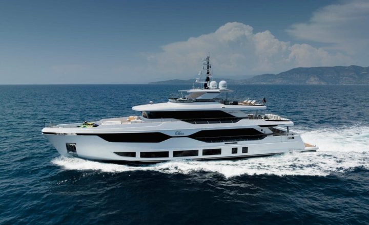 A white and black luxury yacht is cruising on the sea.