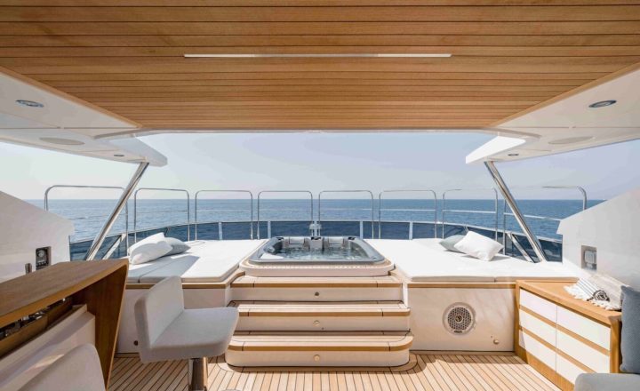 Aft deck of a yacht with a jacuzzi.