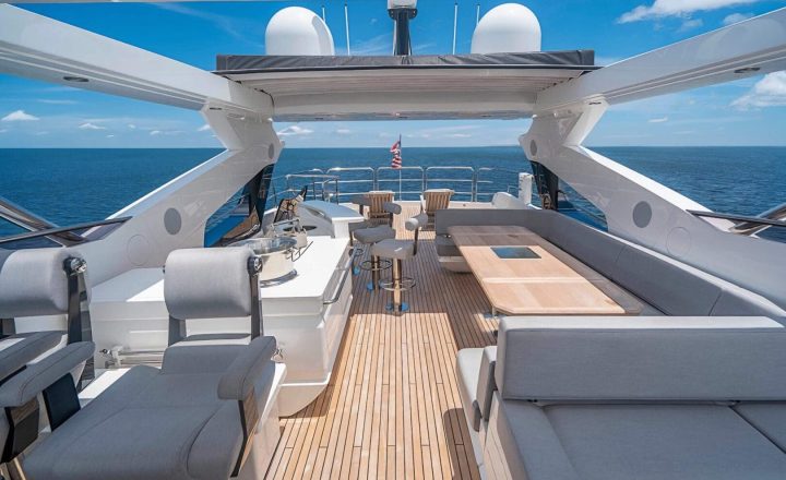 Aft deck of a luxury yacht with seating and dining area.