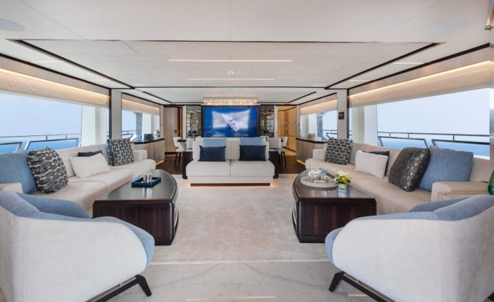 Luxurious yacht saloon with comfortable sofas and armchairs.
