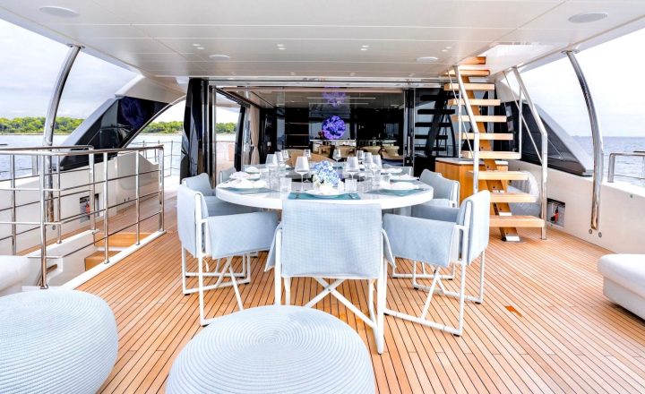 Luxury yacht with outdoor dining area.