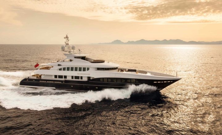 A large white and black yacht on the open sea.