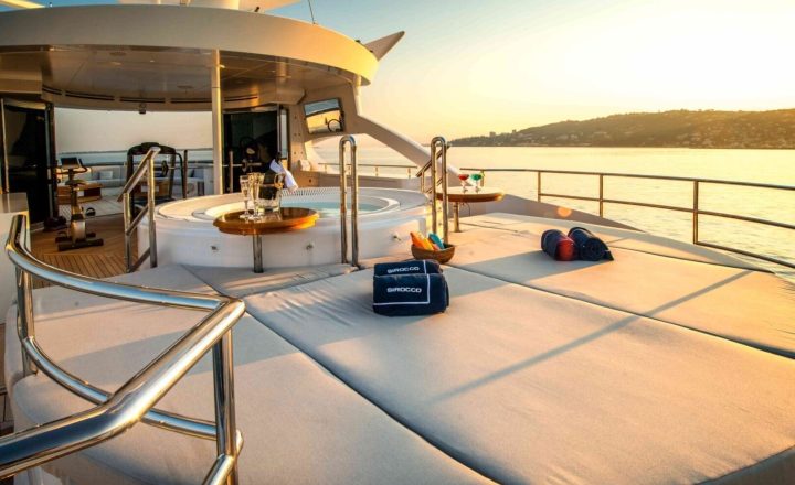 Aft deck of a luxury yacht with jacuzzi and sunbathing area.