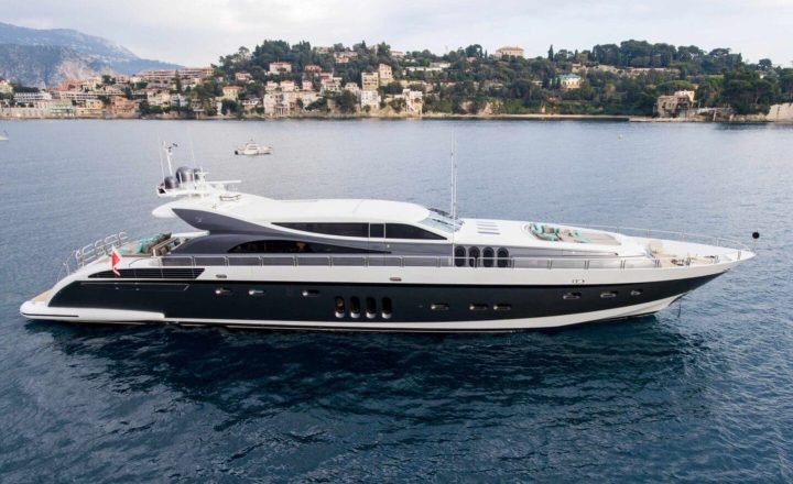 A large white and black yacht on water.