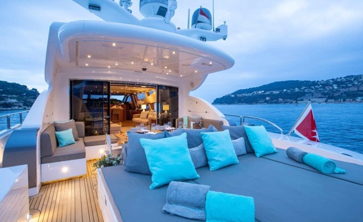 Aft deck of a luxury yacht with blue cushions.